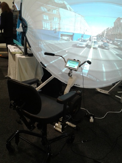 A seated bike with display encourages exercise among the elderly. The sturdy seat ensures that no one falls off the bike. The curved screen tricks the rider’s mind into believing that she is riding her bike outside. 